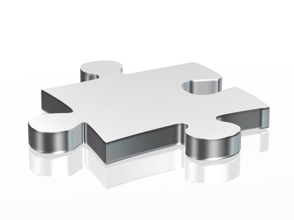 Jigsaw puzzle piece in silver over a white background
